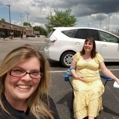 women talking in parking lot
