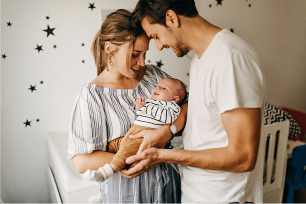 mother and father holding a baby